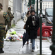 Belgian Army soldiers patrol next to flowers left outside of the French Consulates office in Brussels Saturday, Nov. 21, 2015. Belgium raised it security level to it's highest degree on Saturday as the manhunt continues for extremist Salah Abdeslam who took part in the Paris attacks.